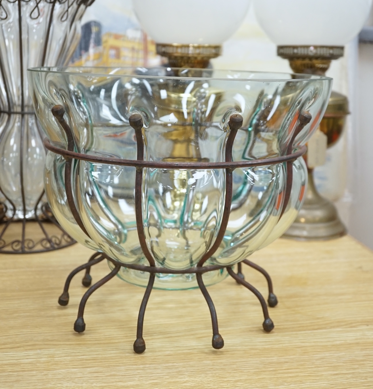 A glass vase and a similar bowl with wrought iron stand, vase 38cm high. Condition - good